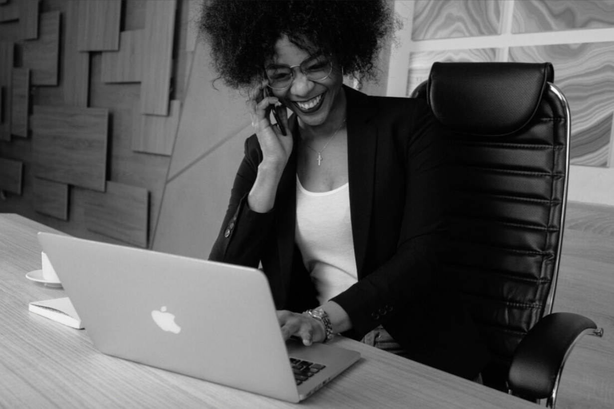 woman on phone with laptop